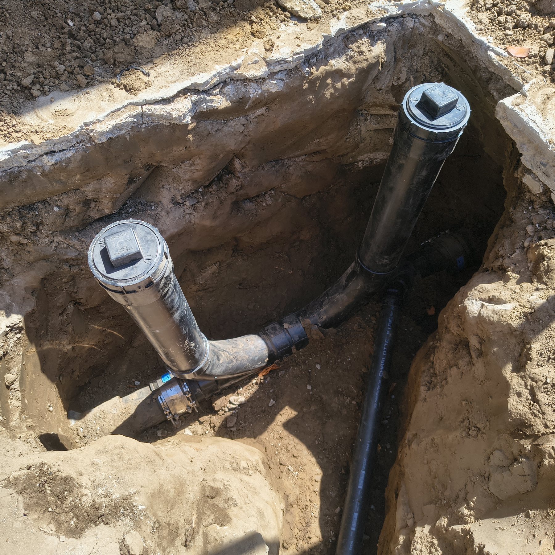 Excavated sewer cleanout and drain piping from a Water Fixers plumbing project