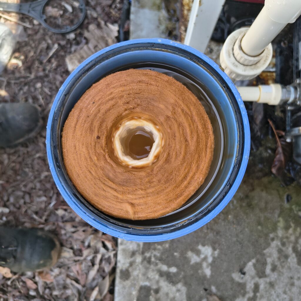 Technician replacing a whole-house filter cartridge